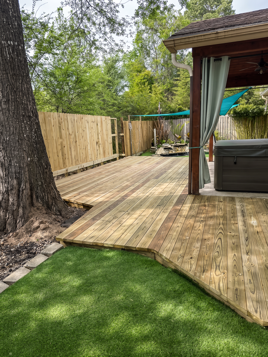 Pressure-treated pine deck with shade sail in Spring TX